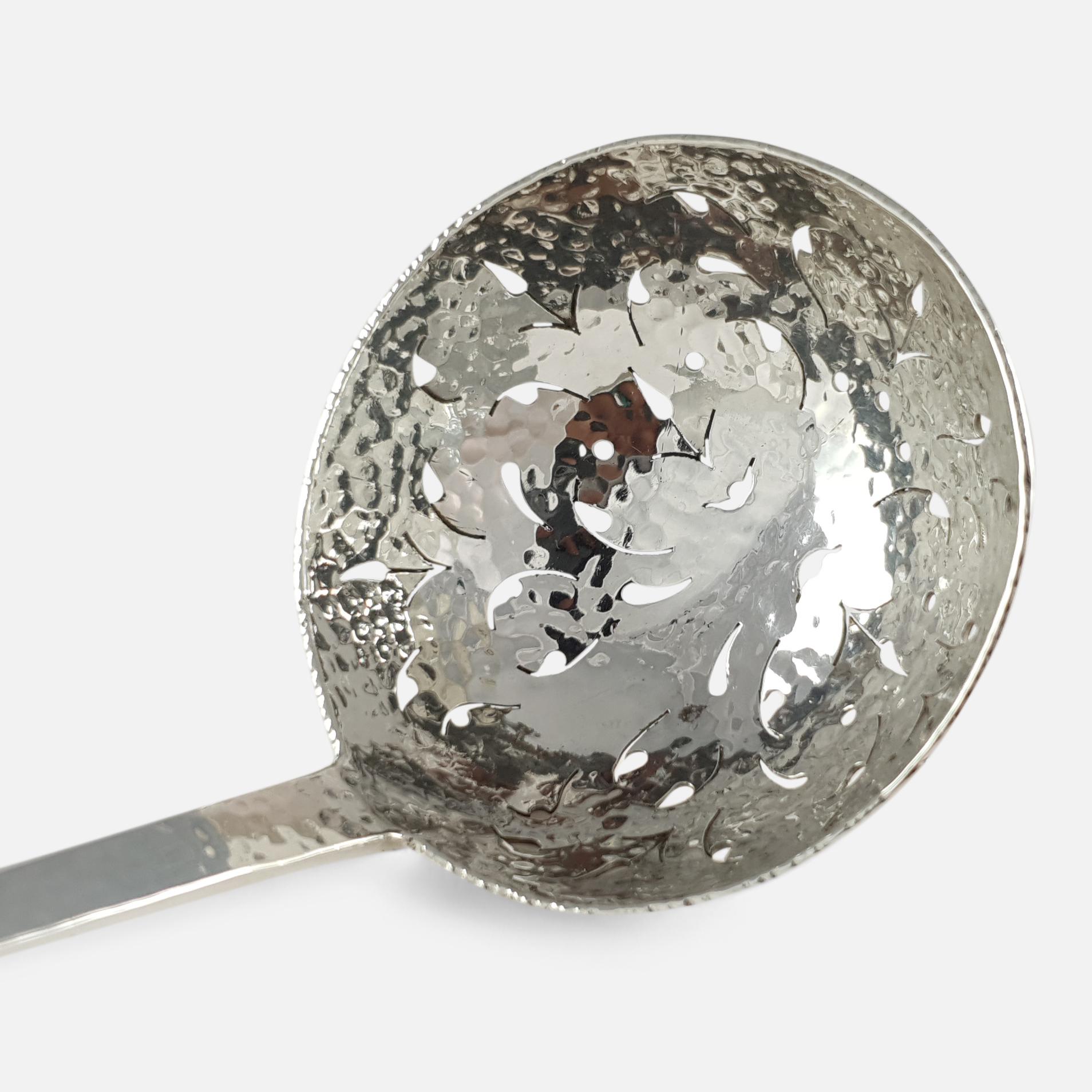 An Edwardian sterling silver spot hammered pierced sugar sifting spoon.

Date: 1903.

Period: Early 20th century.

Engraving: Unengraved.

Maker: Wakely & Wheeler.

Measurement: The sifter measures 16.2cm and the bowl is 5.0cm in diameter.

Weight: