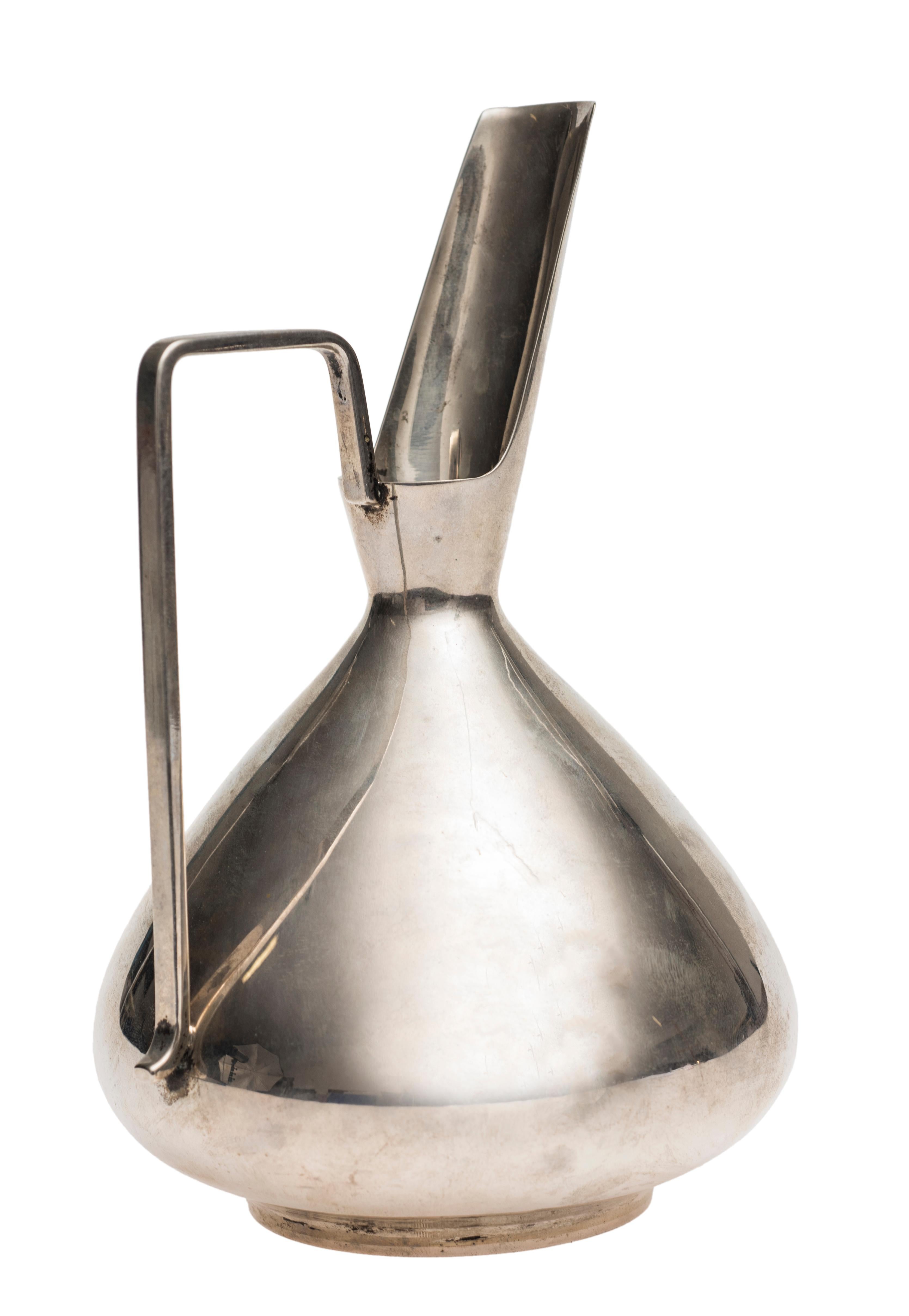 Silver Spout pitcher is an original design object realized by Luigi Genazzi in the 20th century.

Silver; made in Italy.

The signature and the graphic symbol of the artist are on the base: 