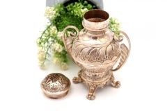 Silver sprinkler with reliefs and applications