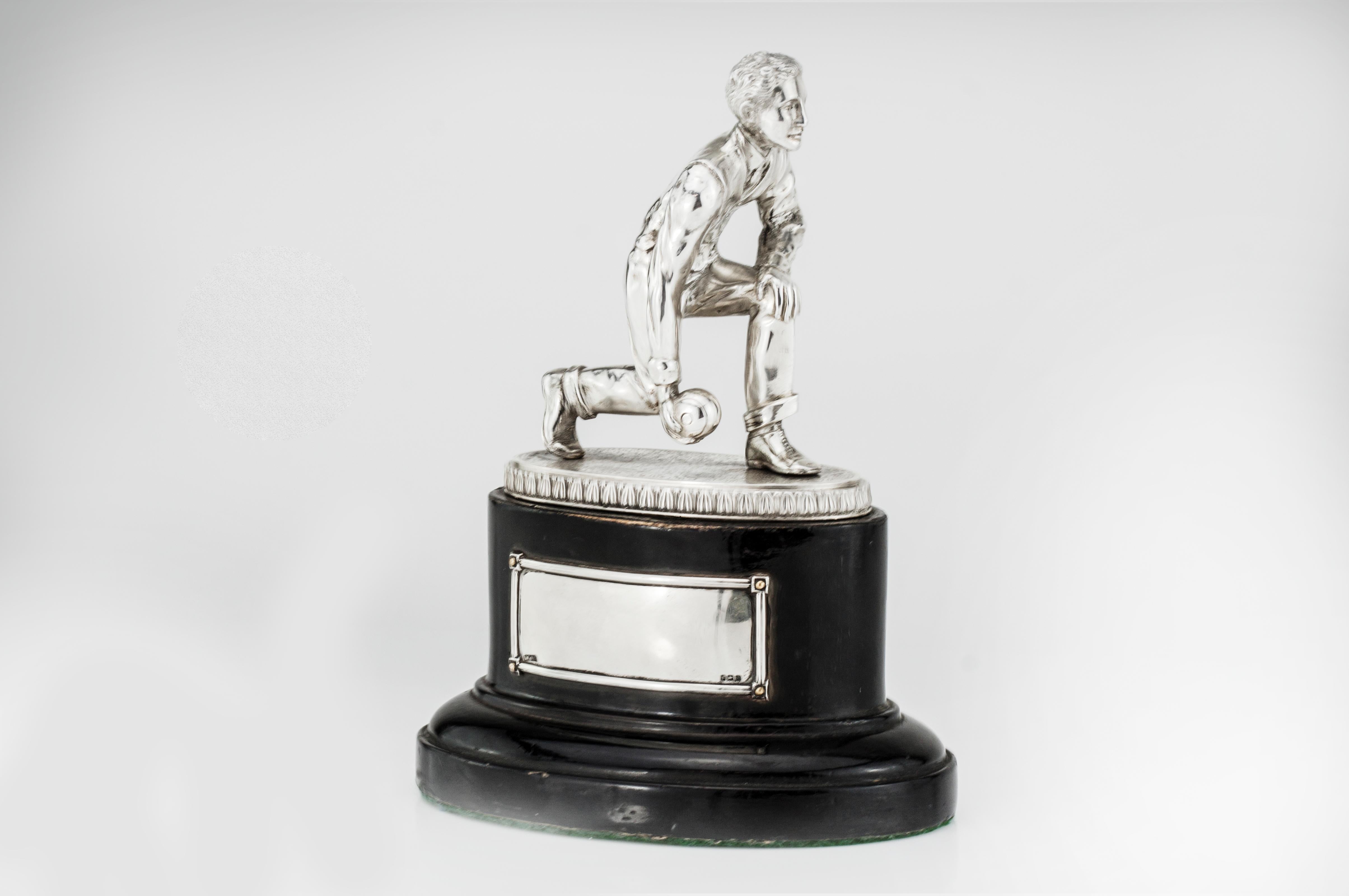 Silver statue 'Bowling player' with a wooden base, used as award or trophy
Maker: W.J.L (unidentified)
Made in 1923
Fully hallmarked.

Dimensions:
Approximate 13 x 8.5 x 17 cm
Weight: 559 grams

Condition: Minor surface wear from general
