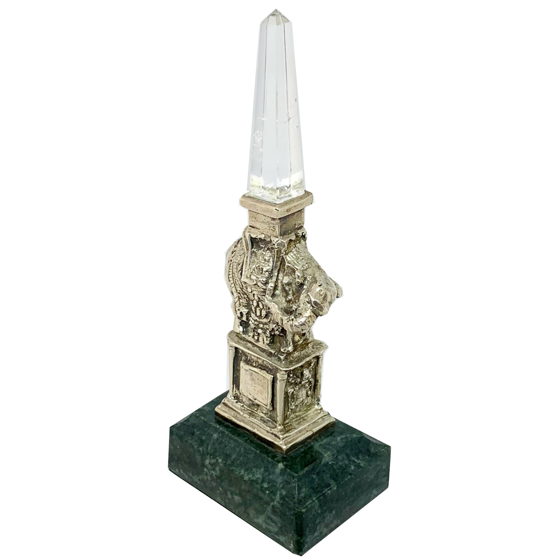This sterling silver and rock crystal statue was made by our talented Roman artisans, and reproduces a famous monument in Rome.
Adjacent to the Pantheon, in front of the Dominican church “Santa Maria Sopra La Minerva” (St.Mary Over Minerva), lies