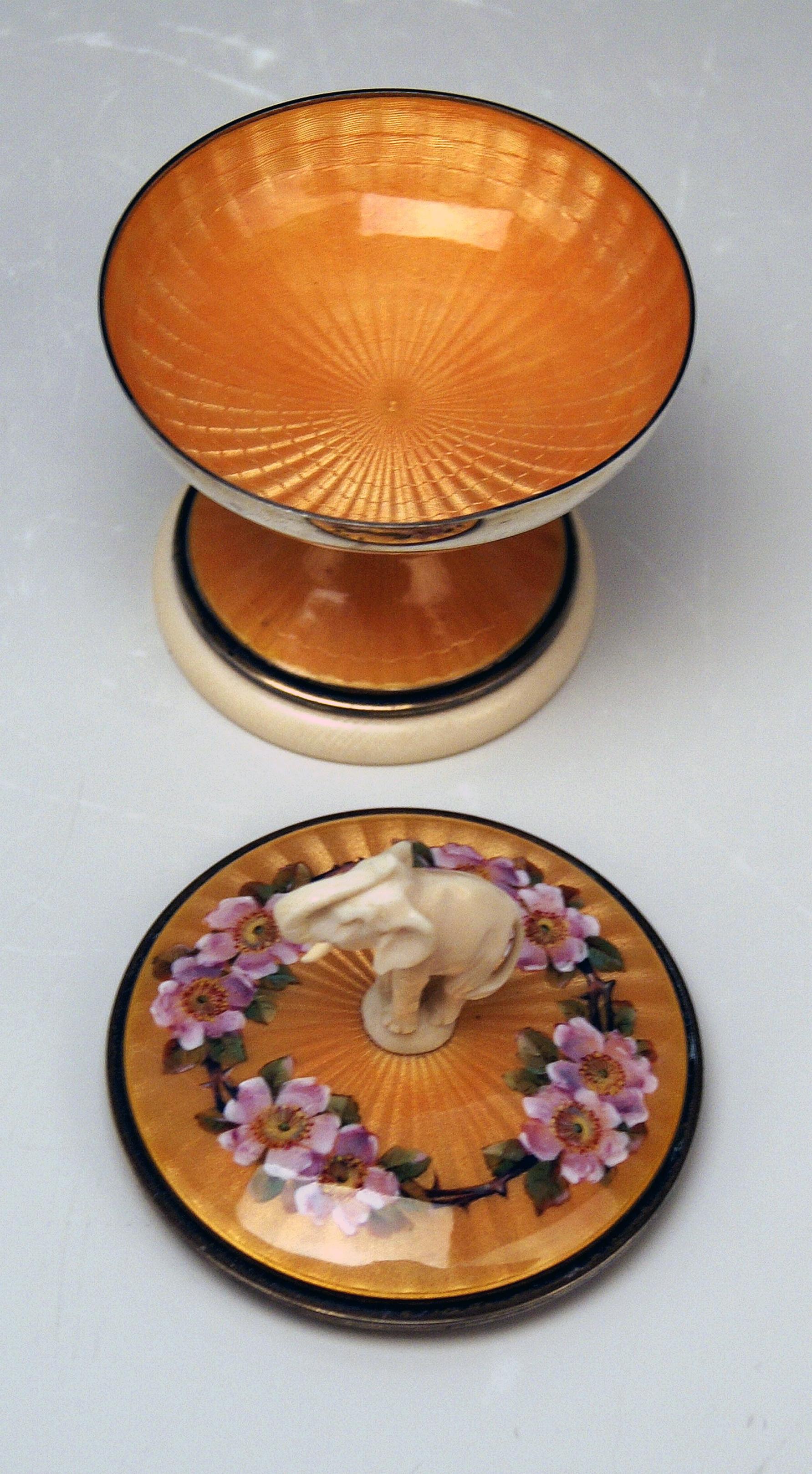 STUNNING SMALL UK SILVER GOBLET ENAMELLED WITH ELEPHANT'S FIGURINE TOPPING LID .

It is a rarest small silver lidded goblet which is stunningly enamelled: 
Color of enamel is shimmering in golden-orange shades / the goblet's lid to which inner