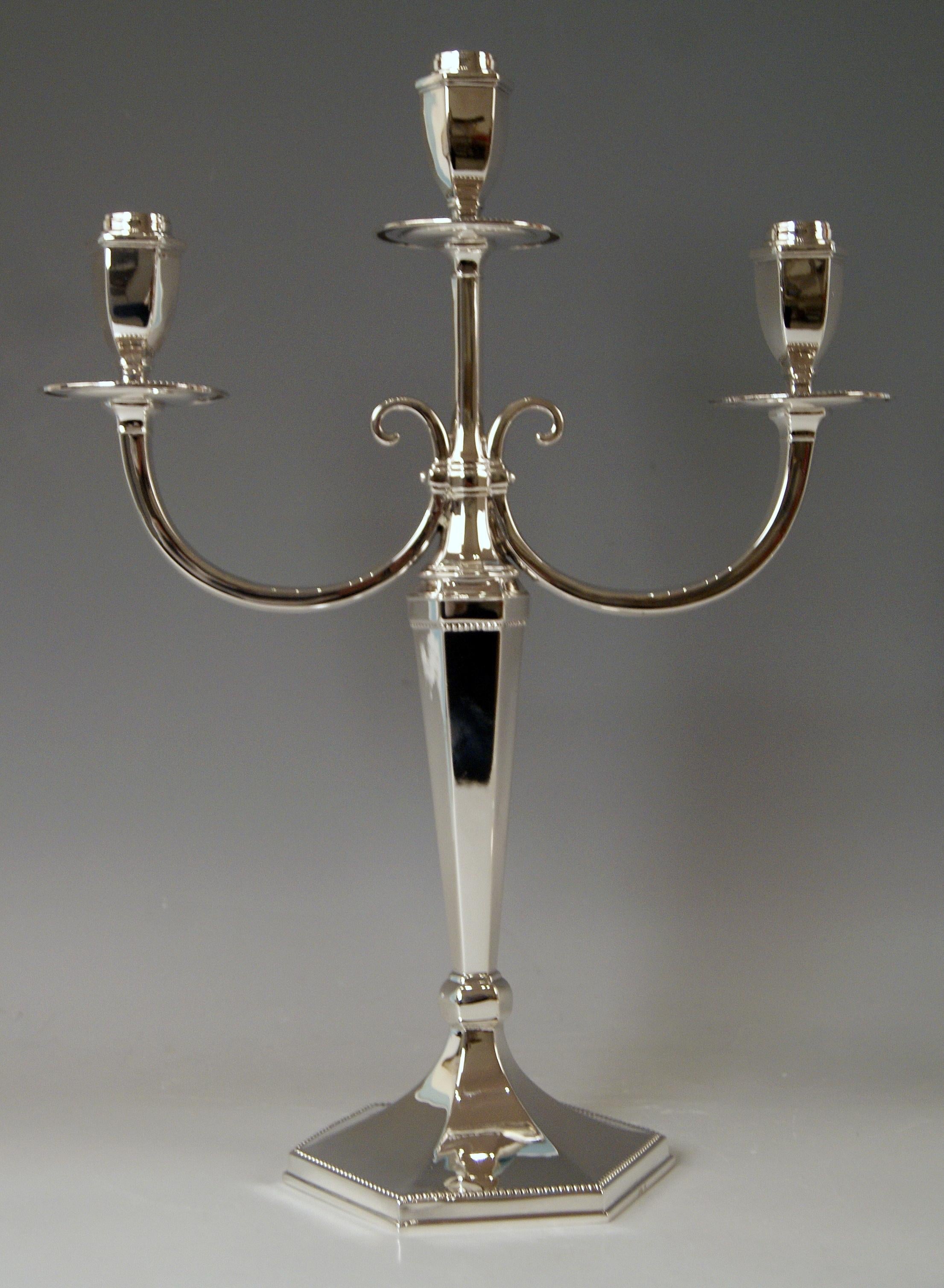 Silver pair of candlesticks of finest manufacturing quality as well as of most elegant appearance.
These three-armed candlesticks were made during Art Deco period (circa 1920).
Surface of candlesticks is smooth / they have tapering stalk with