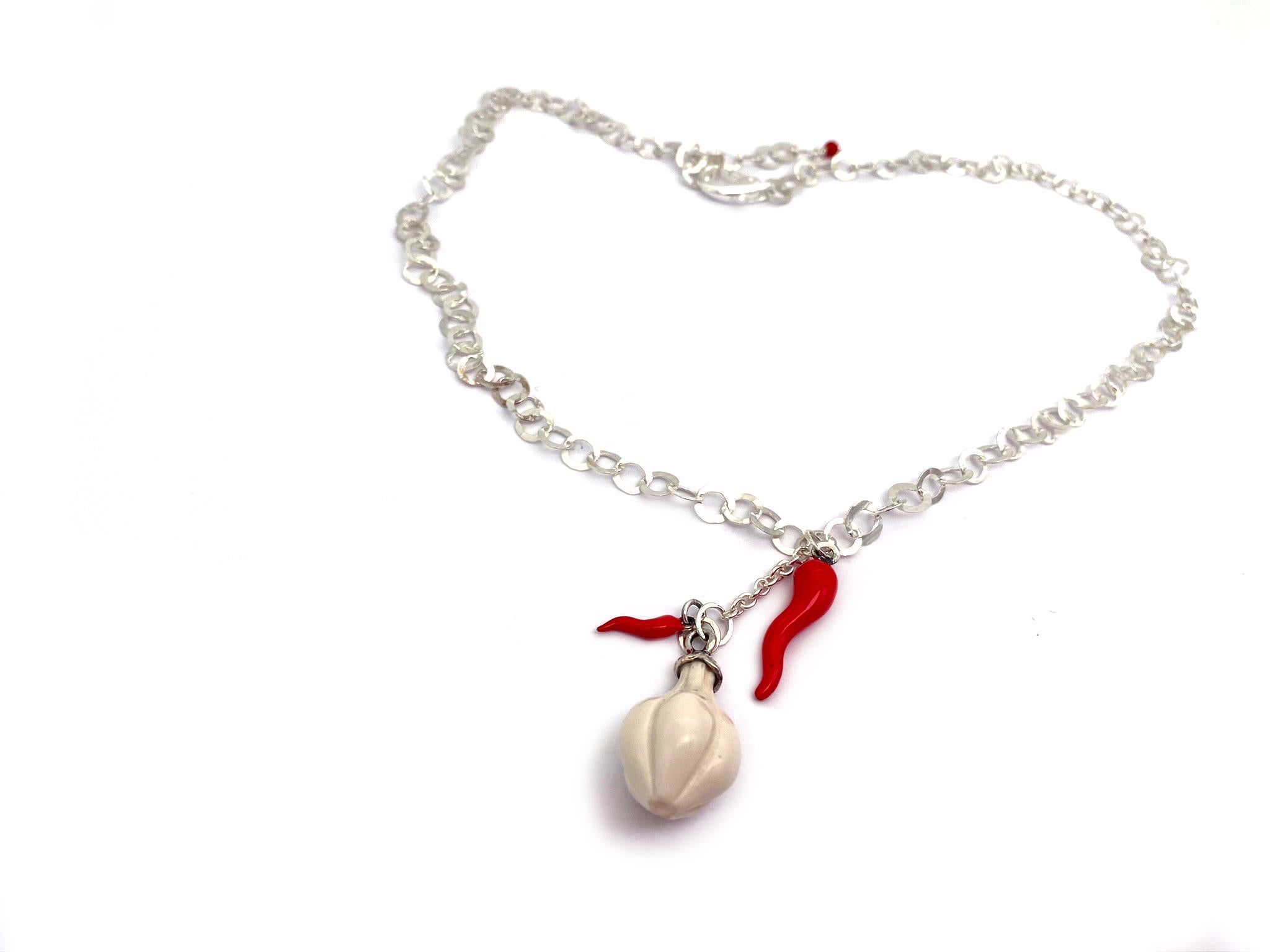 Rossella Ugolini Collection Design Collection Enameled Red Chili Pepper & White Coral Garlic Chain suspended on Silver Sterling White Rhodium: an Amulet Pendant Necklace brings good luck. Adjustable length up to 19.70 inches.
In some areas of Italy,