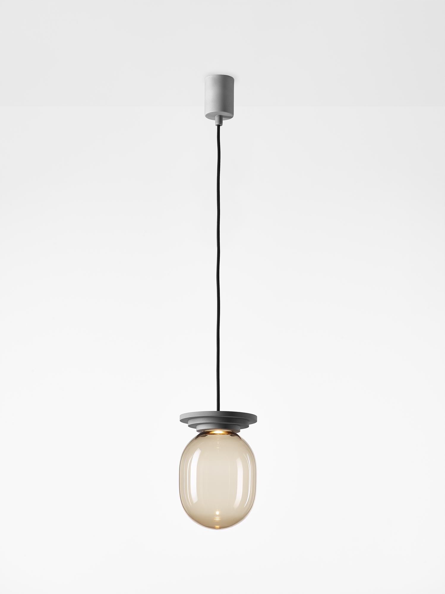 Lampada a sospensione a capsula grande Stratos Silver di Dechem Studio A
Dimensioni: D. 20 x H. 28 cm
Materiali: alluminio, vetro.
Disponibile anche in diversi colori.

Le diverse forme di capsule e sfere contrastano con i fissaggi in lega