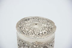 Silver string/wool box with floral reliefs and wavy lid friezes