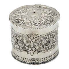 Silver string/wool box with floral reliefs and wavy lid friezes