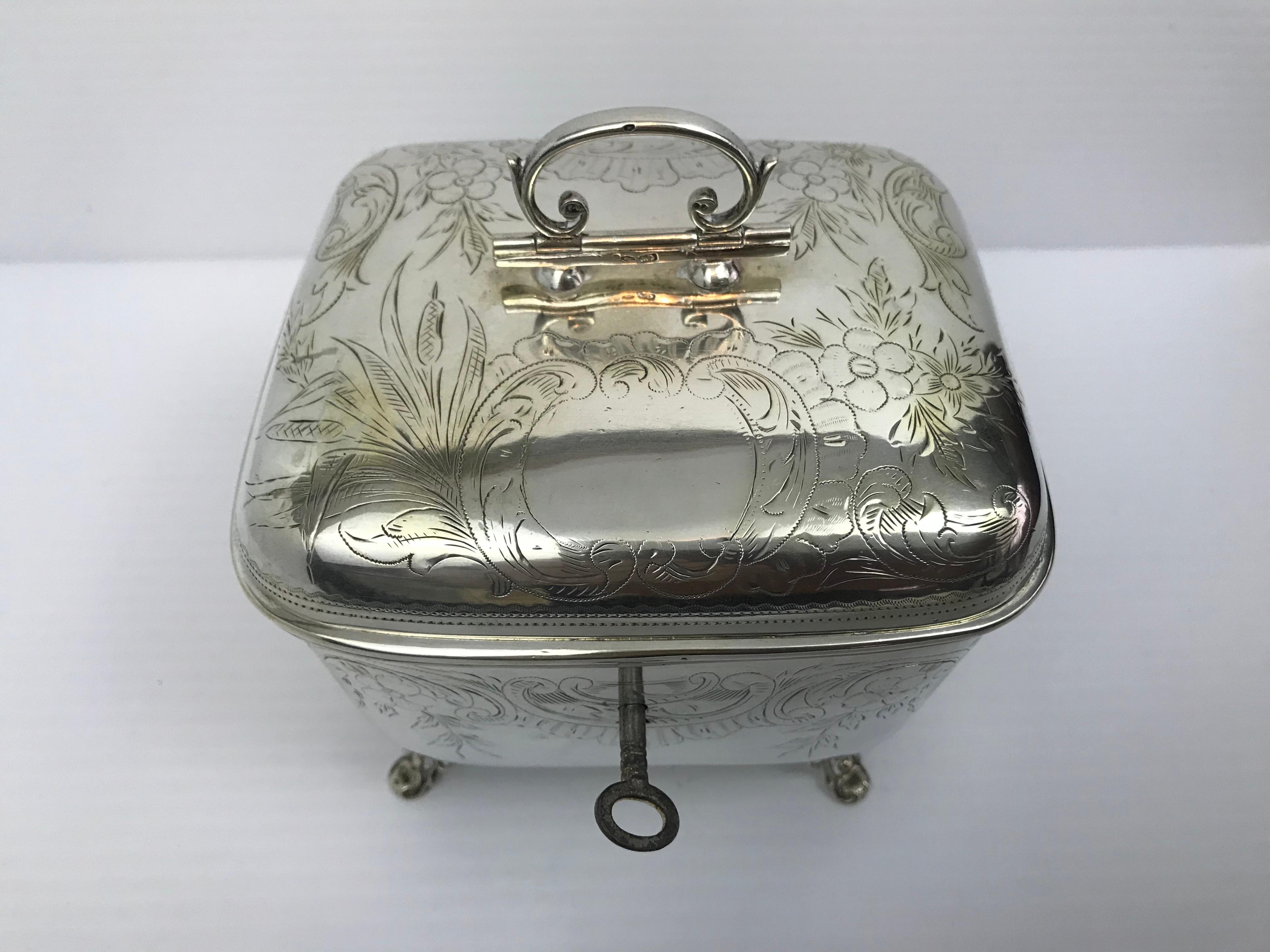 Silver art nouveau sugar bowl made in Austria-Hungary between 1872-1922. Dimension 15cm H x 13 1/2 cm W x 11 cm D. Weight 591 gr, comes with lock and key. Austrian Hallmarks and 800 silver mark decorated with engraving of flower, supported on four