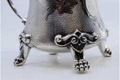 Silver sugar bowl w/ reliefs, applications, monogram plaque & 4 claw feet