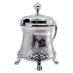 Silver sugar bowl w/ reliefs, applications, monogram plaque
4 claw feet