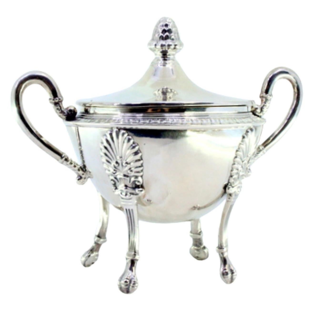 Silver sugar bowl w/ reliefs, friezes, knobbed lid
4 raised claw feet