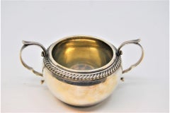 Silver sugar bowl w/ scrolls, embossed w/ shells & resting on 4 zoomorphic feet