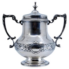 Silver sugar bowl with engravings surrounding a monogram card