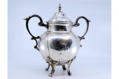 Silver sugar bowl with scrolls, applied handles & four feet