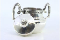 Silver sugar bowl with two beaded handles and a knob on the lid