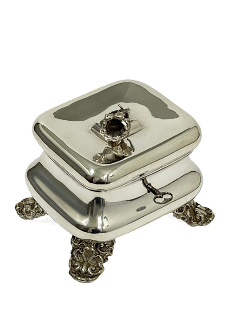 Silver sugar box raised on four feet, Vienna Austria, 1853

A square silver Austrian box in round bomb form with hinged cover and floral knob, raised on four feet.
Silver Hall mark of Austrian Silver, From Vienna, dated 1853
The silver purity is