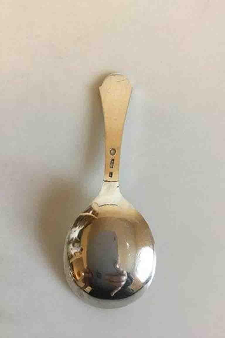 Silver sugar spoon.

Measures 11 cm / 4 21/64 in.
 