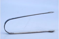 Silver sugar tongs with engraved elements and friezes on the edge
