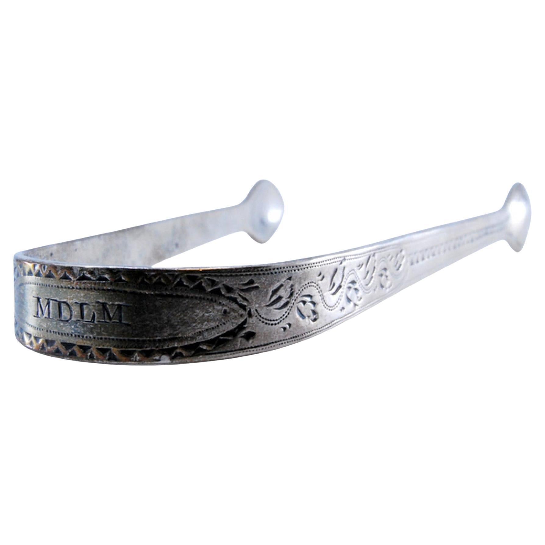Silver sugar tongs with engraved elements and friezes on the edge
