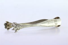 Silver sugar tongs with floral reliefs, friezes and claw-shaped tongs