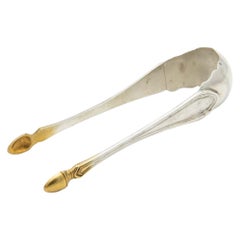 Silver sugar tongs with gold tips