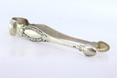 Silver sugar tongs with reliefs and monogram cards