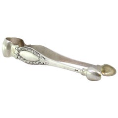 Silver sugar tongs with reliefs and monogram cards