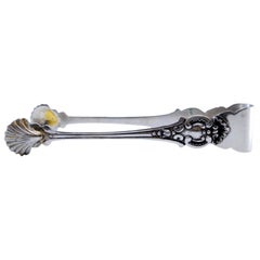 Silver sugar tongs with reliefs and scallop shells