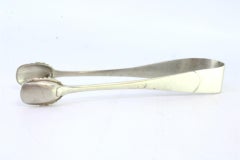 Silver sugar tongs with shell-shaped cutouts on the tongs