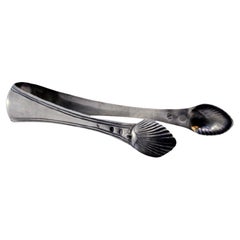 Silver sugar tongs with shell-shaped trim and tongs