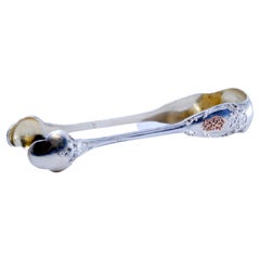 Silver sugar tongs with traces of gold on both sides