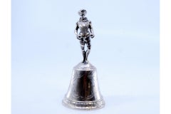 Silver table bell with reliefs and harlequin figure