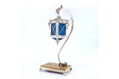 Silver table lamp suspended on relief structure, marble base with railing