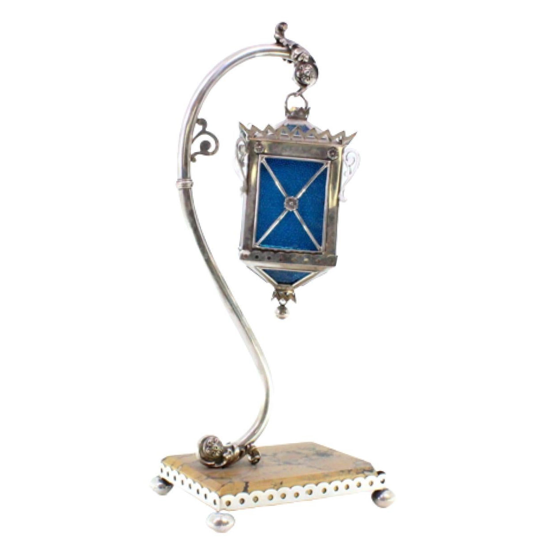 Silver table lamp suspended on relief structure, marble base with railing