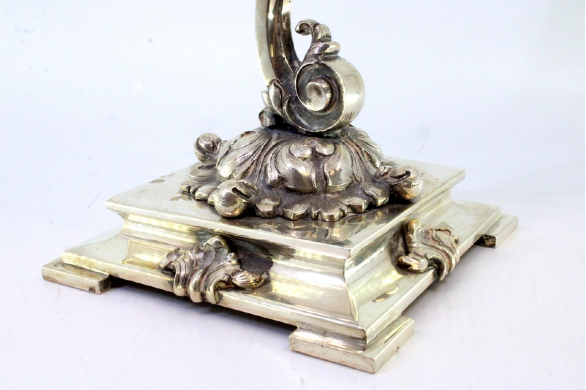 Description : Lampe de table en argent suspendue à une structure surélevée et reposant sur une base surélevée et électrifiée. Métal : Argent. Origine : Portugais. Poinçon : aigle debout. Poids : 1450,31 grammes. Dimensions : 13,7 cm x 32 cm : 13,7cm