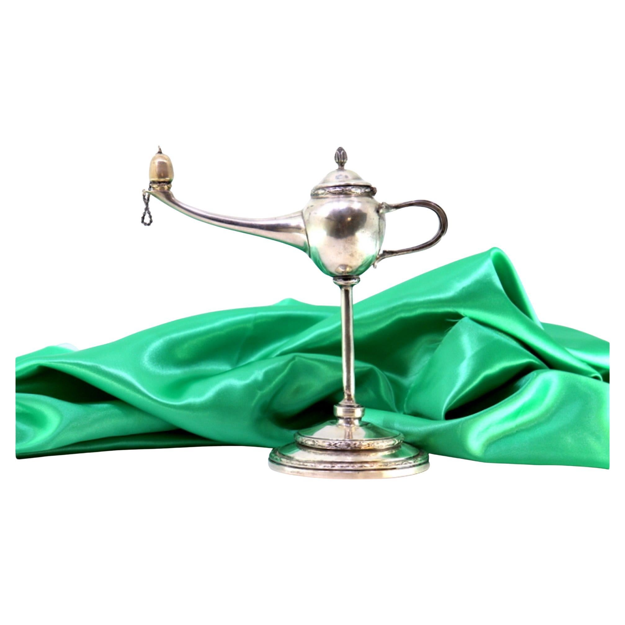 Silver table lamp with reliefs, knobbed lid, on circular beaded base