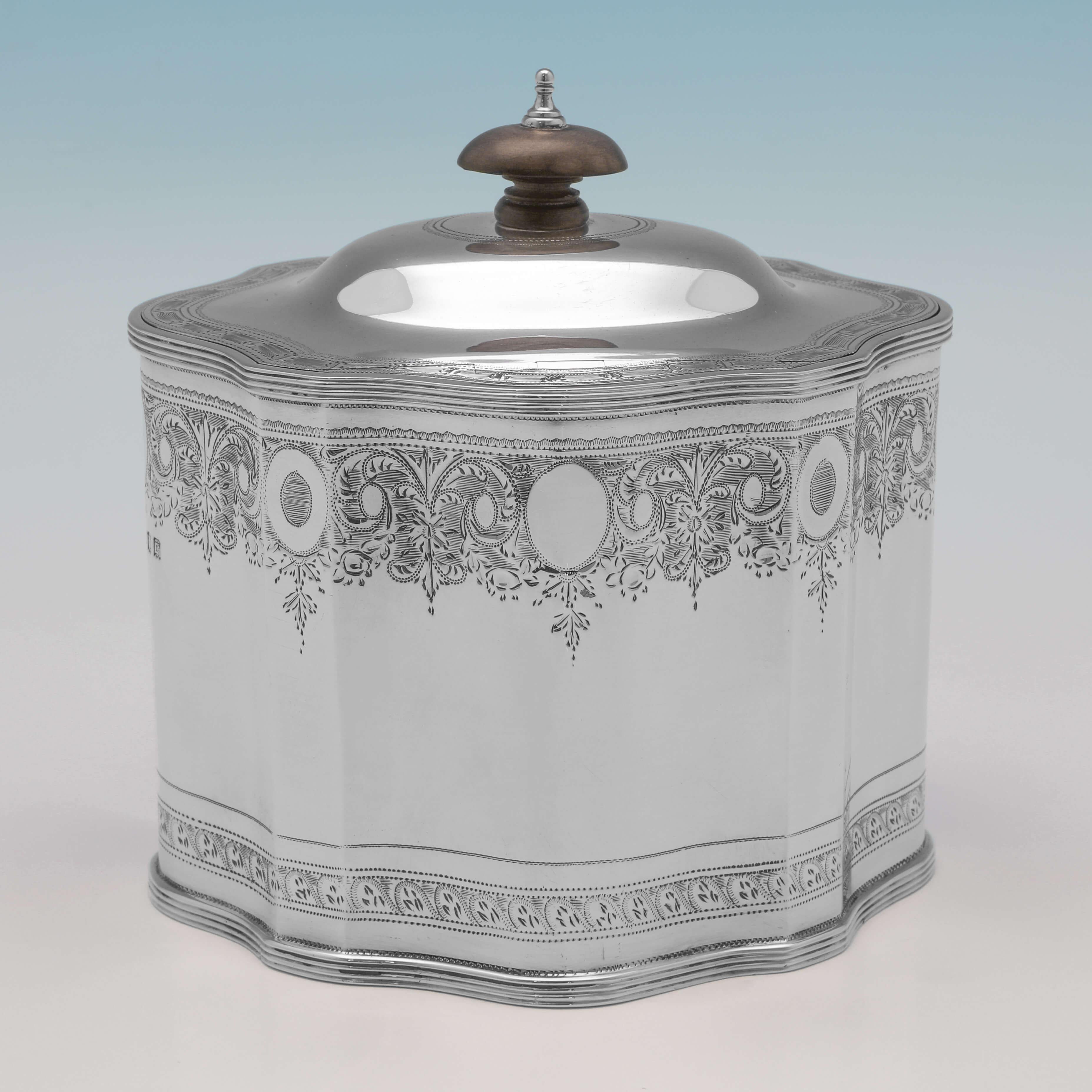 Hallmarked in London in 1918 by L. A. Crichton, this stunning, Antique Sterling Silver Tea Caddy, is in the Neoclassical taste, featuring engraved decoration throughout. The tea caddy comes from the collection of Former President of the United