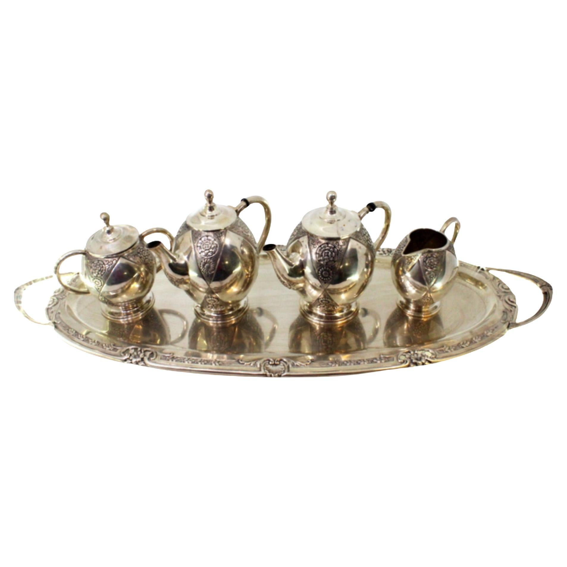 Silver tea 
coffee service with kettle, tray 
relief cutouts