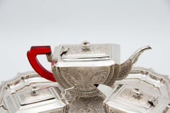 Silver tea service with tray, cups, saucers, teapot, coffee pot and sugar bowl