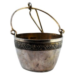 Silver tea strainer with rim and hinged handle