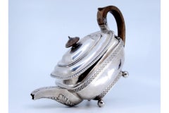 Silver teapot with chestnut handle, pearly rim and floral spout motifs