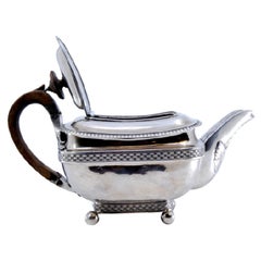Silver teapot with chestnut handle, pearly rim and floral spout motifs