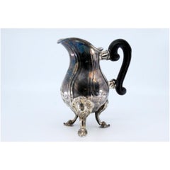 Silver teapot with shell shape and chestnut wood handle