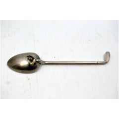 Silver teaspoon shaped like a golf club handle