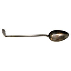 Silver teaspoon shaped like a golf club handle