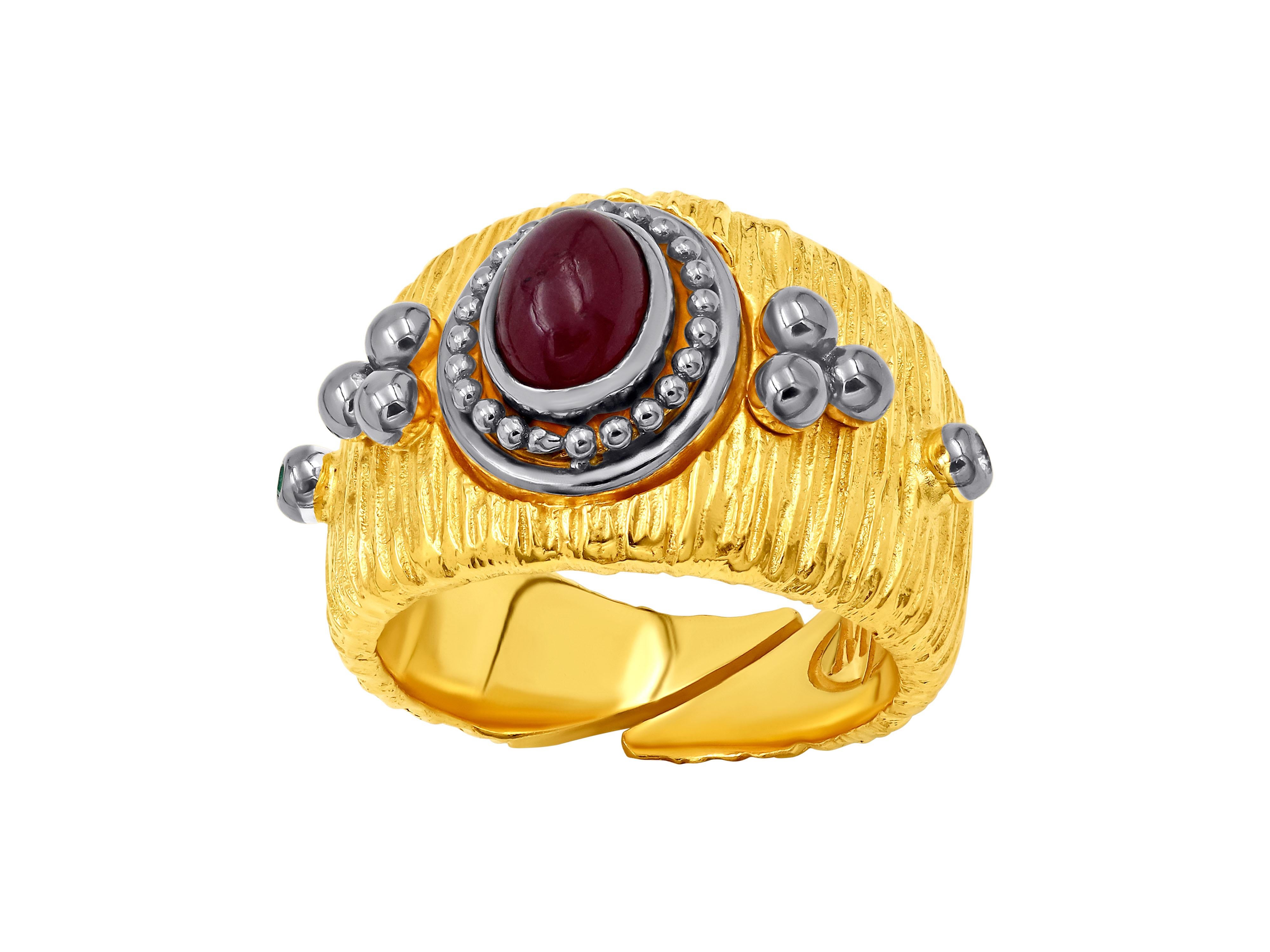 Silver gold-plated textured ring encrusted with a magnificent combination of tourmaline, emerald, and citrine gemstones. The ring showcases an exquisite design with intricate golden texture. The central attraction of the ring is a stunning, red