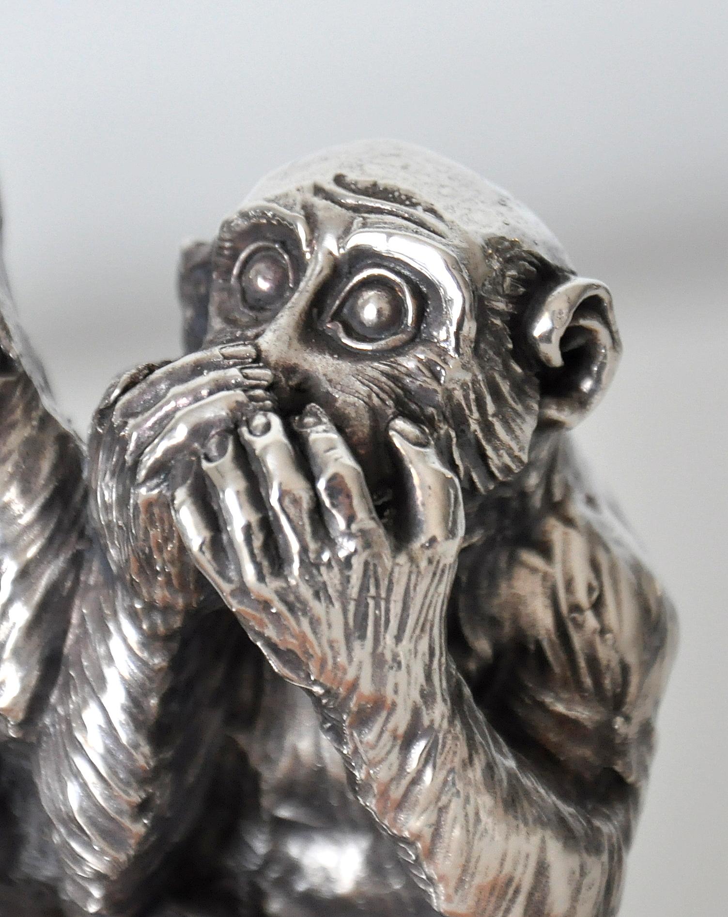 A vintage sterling silver clad statue depicting the three mystic apes Mizaru who sees no evil, Kikazaru who hears no evil, and Iwazaru who speaks no evil. The finely detailed See no evil, Hear no evil, Speak no evil sculpture sits atop a rectangular