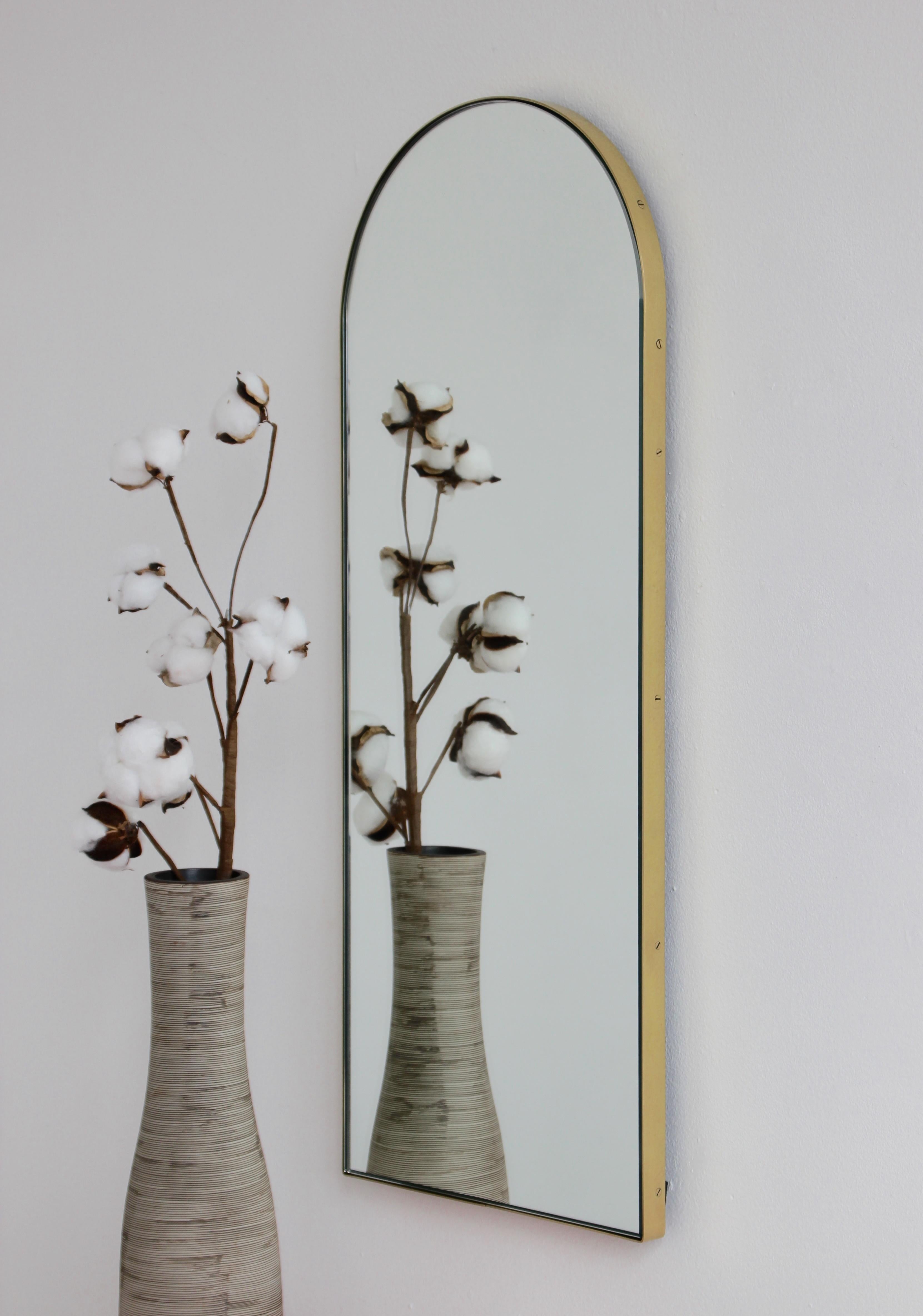 Delightful arch shaped narrow mirror with an elegant solid brushed brass frame. Designed and handcrafted in London, UK.

Fitted with a brass hook or an aluminium z-bar depending on the size of the mirror. Also available on demand with a split batten