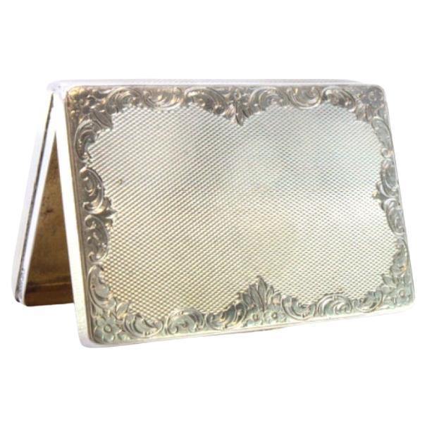 Silver tobacco box with guilloche floral motifs, gold interior and hinged lid
