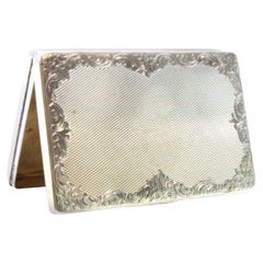Silver tobacco box with guilloche floral motifs, gold interior and hinged lid